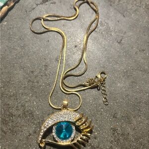 Gold Eye Pendant Necklace with Blue Gemstone